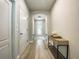 Inviting hallway with light wood floors, neutral walls, and modern console table at 12795 Bosworth Ave, Windermere, FL 34786