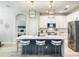Contemporary kitchen featuring white cabinets, an island with seating, and modern pendant lighting at 12795 Bosworth Ave, Windermere, FL 34786