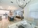 Open kitchen and living space, featuring a large island, modern lighting, and stainless appliances at 12795 Bosworth Ave, Windermere, FL 34786