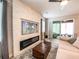 Cozy living room featuring a stone accent wall with fireplace and large sliding glass doors at 12795 Bosworth Ave, Windermere, FL 34786