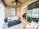 Enclosed outdoor patio with neutral furniture, fire pit table, and a view inside at 12795 Bosworth Ave, Windermere, FL 34786