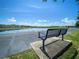 Scenic community pond view with blue skies and bench seating available at 12795 Bosworth Ave, Windermere, FL 34786