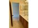 Bright bathroom featuring a double sink vanity with wood cabinets and tile flooring at 1354 Knollwood Dr, Davenport, FL 33837
