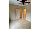 Empty bedroom with tile floors, ceiling fan, and entry door at 1354 Knollwood Dr, Davenport, FL 33837