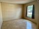 Well-lit bedroom featuring a window and tile flooring at 1354 Knollwood Dr, Davenport, FL 33837