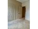 Bedroom showcasing an open entry door, tiled flooring, and closet at 1354 Knollwood Dr, Davenport, FL 33837