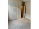 Bedroom featuring closet doors and tile flooring at 1354 Knollwood Dr, Davenport, FL 33837
