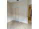 Bedroom area showcasing closet doors and an entrance to another room at 1354 Knollwood Dr, Davenport, FL 33837