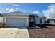 Charming single-Gathering home with a well-maintained lawn and two-car garage in a suburban neighborhood at 1354 Knollwood Dr, Davenport, FL 33837