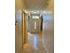 Hallway featuring tile flooring leading to the front door with glass detailing at 1354 Knollwood Dr, Davenport, FL 33837
