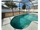 Screened-in pool with clear water and surrounding patio furniture at 1354 Knollwood Dr, Davenport, FL 33837