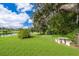 Expansive backyard with lush grass, garden area and serene lake views at 1504 E Gore St, Orlando, FL 32806