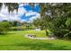 Lush backyard landscaping leading to tranquil lake views at 1504 E Gore St, Orlando, FL 32806