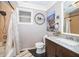 A bathroom featuring a dark vanity with marble countertop and black tile floors at 1504 E Gore St, Orlando, FL 32806