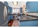 This kitchen features light blue cabinets, granite counters, and stainless steel appliances at 1504 E Gore St, Orlando, FL 32806