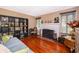 Comfortable living room with hardwood floors, featuring a fireplace and ample natural light at 1504 E Gore St, Orlando, FL 32806