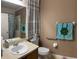 Cozy bathroom features a vanity with sink, toilet, and shower, enhanced by neutral wall colors and decor at 1574 Derby Glen Dr, Orlando, FL 32837