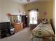 Cozy bedroom features a twin bed, dresser with mirror, and soft natural light at 1574 Derby Glen Dr, Orlando, FL 32837