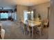 Dining room connected to a living room, features a table with chairs and a chandelier at 1574 Derby Glen Dr, Orlando, FL 32837