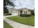 Charming single-story home featuring a two-car garage and well-manicured lawn at 1574 Derby Glen Dr, Orlando, FL 32837