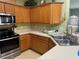 Kitchen featuring stainless steel appliances, oak cabinets, and stylish countertops at 1574 Derby Glen Dr, Orlando, FL 32837