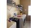 Functional laundry room with machines, storage shelves, and a utility sink at 1574 Derby Glen Dr, Orlando, FL 32837