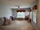 Open living room with carpet, ceiling fan, and natural light through large windows at 1574 Derby Glen Dr, Orlando, FL 32837