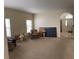 Spacious living room with neutral walls, carpet, and ample natural light at 1574 Derby Glen Dr, Orlando, FL 32837