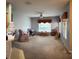 Spacious living room featuring neutral walls, carpet flooring, and ample natural light from large windows at 1574 Derby Glen Dr, Orlando, FL 32837