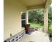 Covered patio area with a view of the landscaped backyard and greenery at 1574 Derby Glen Dr, Orlando, FL 32837
