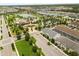Aerial view showcases community amenities like a pool, clubhouse, and lush landscaping at 1592 Carey Palm Cir, Kissimmee, FL 34747