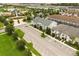 Aerial view of a residential neighborhood featuring condo buildings, lakes, and mature landscaping at 1592 Carey Palm Cir, Kissimmee, FL 34747