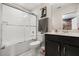 Clean bathroom with a shower-tub combination, sleek vanity, and bright lighting at 1592 Carey Palm Cir, Kissimmee, FL 34747