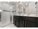 Updated bathroom with a glass-enclosed shower, dual sink vanity, and neutral tile flooring at 1592 Carey Palm Cir, Kissimmee, FL 34747