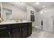 Well-lit bathroom features a spacious vanity with dark cabinets and a glass-enclosed shower at 1592 Carey Palm Cir, Kissimmee, FL 34747