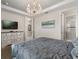 Spacious primary bedroom boasts a chandelier, TV and a view into the en suite bathroom at 1592 Carey Palm Cir, Kissimmee, FL 34747