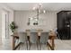 Bright dining room featuring a modern chandelier, gray chairs, and a large mirror for an open, airy feel at 1592 Carey Palm Cir, Kissimmee, FL 34747