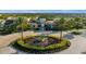 Community entrance with lush landscaping and a central water feature, creating a welcoming and impressive arrival at 1592 Carey Palm Cir, Kissimmee, FL 34747