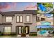Inviting townhouse featuring a well-manicured landscape and exterior with multiple community pool images at 1592 Carey Palm Cir, Kissimmee, FL 34747