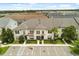 Exterior of a multi-Gathering home with parking spaces, landscaping, and architectural details at 1592 Carey Palm Cir, Kissimmee, FL 34747