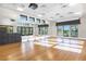 The well-lit fitness center features a wall of mirrors, wood floors, and floor-to-ceiling windows with picturesque views at 1592 Carey Palm Cir, Kissimmee, FL 34747