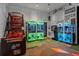 Fun game room with claw machines, basketball arcade, and a fun wall mural at 1592 Carey Palm Cir, Kissimmee, FL 34747