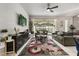 Stylish living room with a modern accent wall, sleek furnishings, and sliding glass doors at 1592 Carey Palm Cir, Kissimmee, FL 34747