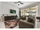 Inviting living room featuring textured wall, modern furniture, and a sliding glass door to the patio at 1592 Carey Palm Cir, Kissimmee, FL 34747