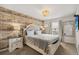 Comfortable main bedroom with wood accent wall, soft lighting, and neutral color palette for a tranquil retreat at 1592 Carey Palm Cir, Kissimmee, FL 34747