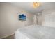Bright main bedroom with neutral tones, ceiling fan, and access to en-suite bathroom at 1592 Carey Palm Cir, Kissimmee, FL 34747