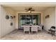 Covered patio with dining table set, ceiling fan, and access to the home's interior at 1592 Carey Palm Cir, Kissimmee, FL 34747