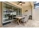 Covered patio with dining table set, ceiling fan, and sliding glass doors at 1592 Carey Palm Cir, Kissimmee, FL 34747