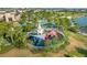 Outdoor playground featuring slides and play structures, surrounded by lush landscaping and a safety fence at 1592 Carey Palm Cir, Kissimmee, FL 34747