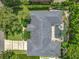 An aerial shot of a home featuring a screened-in pool area, manicured lawns, mature trees, and a driveway at 1640 Mayfield Ave, Winter Park, FL 32789